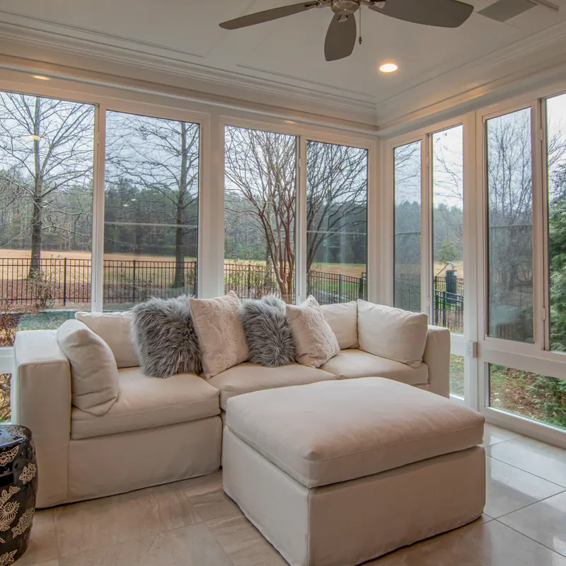 Bright finished room with a wall of residential windows