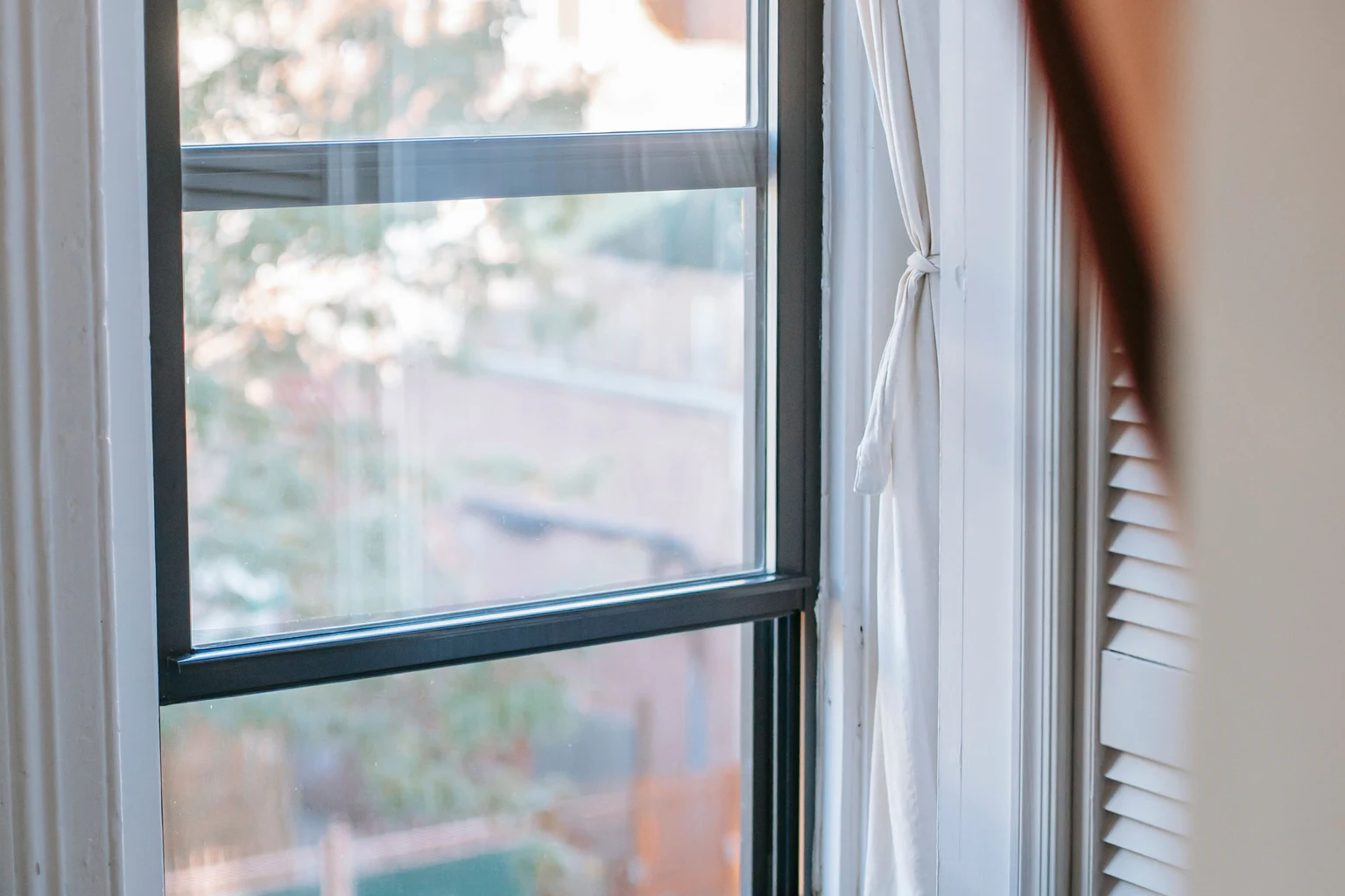 Close interior view of a residential double-hung window and meeting rail
