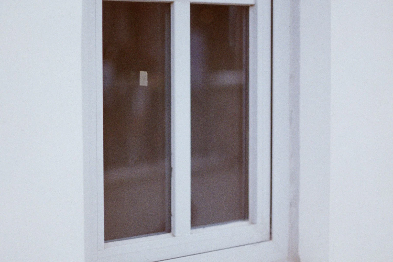 Close exterior detail of a white factory-finished residential window frame